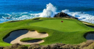 Coastal golf course with waves crashing behind the green