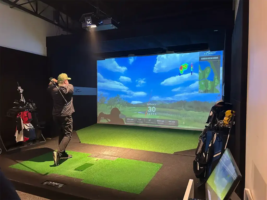 Golfer watches his shot track to 30 yards as the simulator displays an impact heat map and swing data.