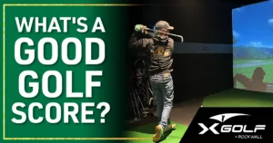 Golfer checking score on simulator screen at X-Golf Rockwall