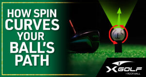 Golf driver clubhead positioned beside a golf ball on a tee over green turf, with two red circular arrows illustrating sidespin and a green arrow showing diverging ball flight paths; text reads "How Spin Curves Your Ball's Path" with the X Golf Rockwall logo